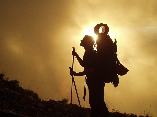 trekking backpack sunset silhouette climbing