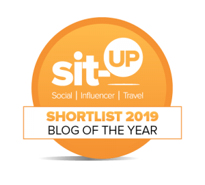 orange circular badge, the text in white reads: Sit-up social influencer travel shortlist 2019 blog of the year"