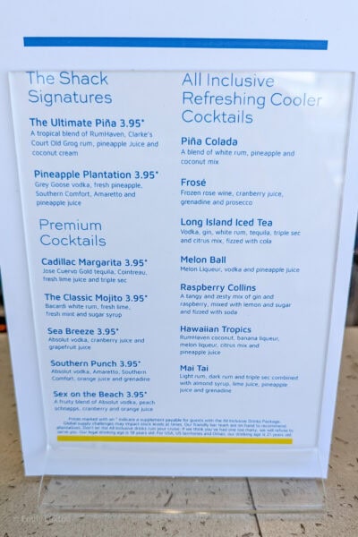 close up of a white menu with blue text listing different cocktails