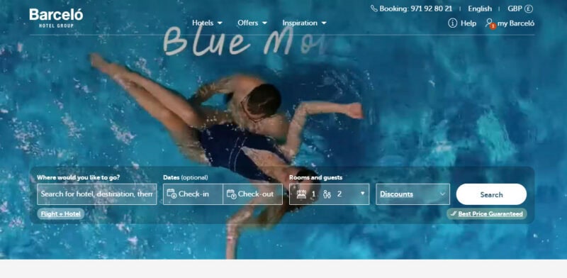 Screenshot from the Barceló Hotel Group website showing a pool with two synchronized swimmers, partially overlaid with the text 'Blue Mo.'