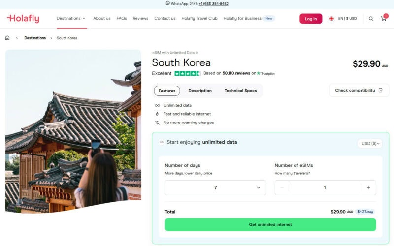 Webpage from Holafly offering an eSIM for South Korea with unlimited data at $29.90 USD. It highlights benefits like fast internet, no roaming charges, and features a person photographing traditional Korean architecture. Options to select the number of days and eSIMs are shown.