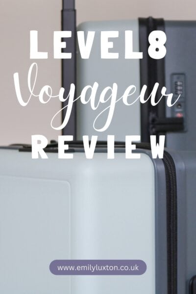 Level8 Voyageur Review : written in white text over a photograph of two grey-blue hardshell suitcases in close up. 