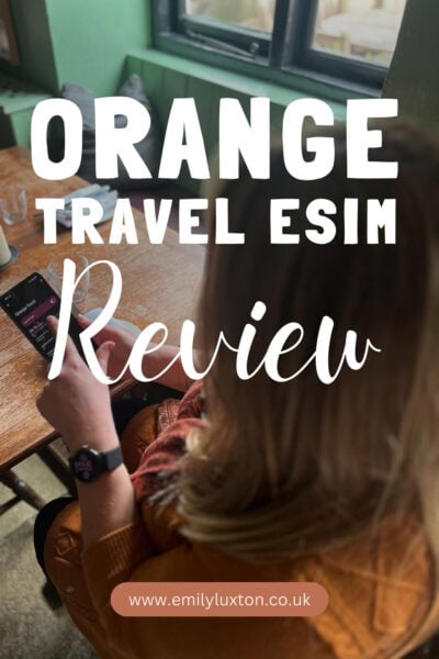 Orange Travel eSIM Review: written in white text over a photo showing a girl with blonde hair using the settings app on her smartphone. 